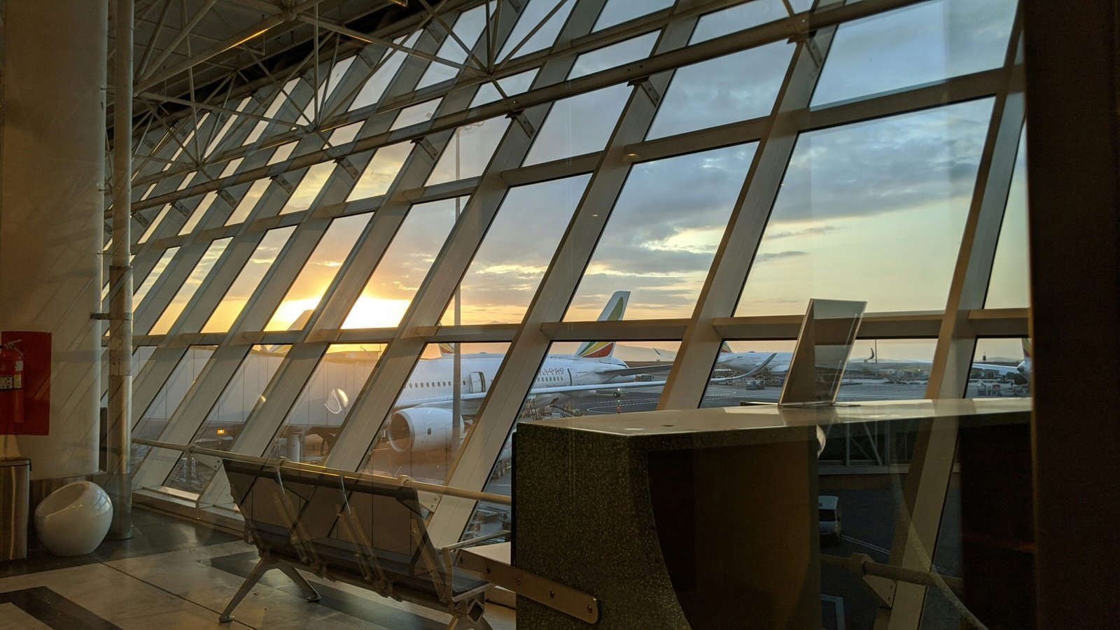 brown wooden table near glass window